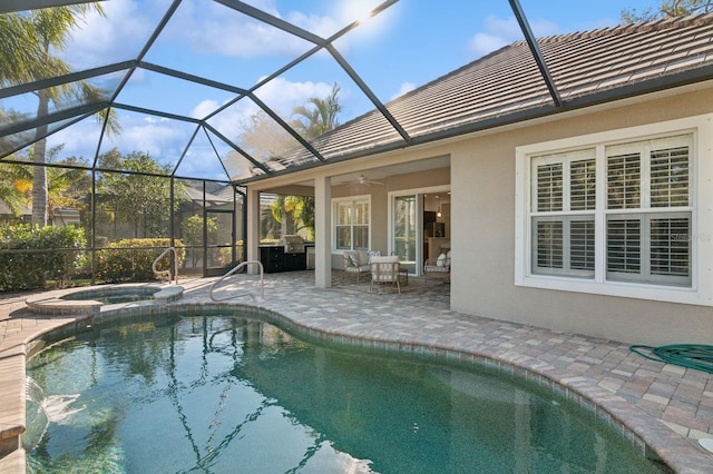 view of pool with an in ground hot tub, glass enclosure, ceiling fan, and a patio area