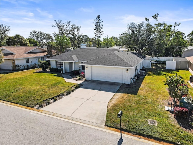 ranch-style house featuring a garage and a front lawn