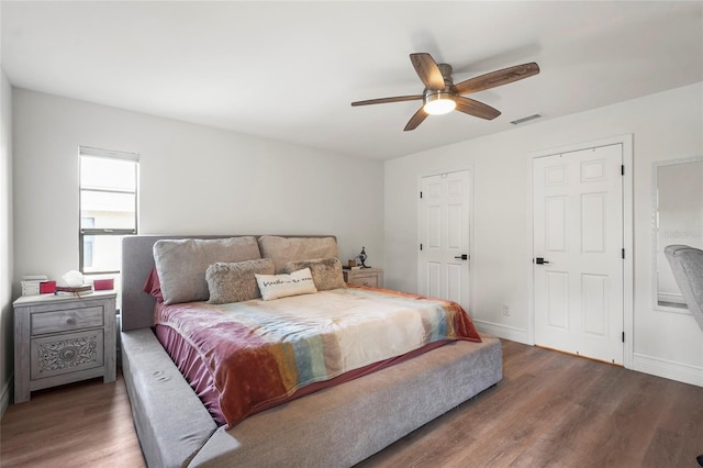 bedroom featuring dark hardwood / wood-style floors and ceiling fan