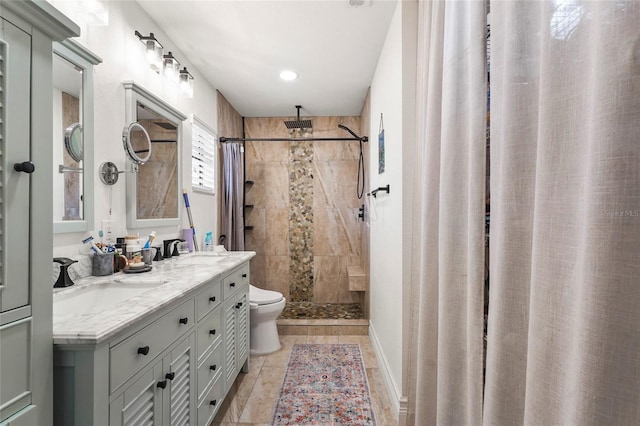 bathroom with walk in shower, vanity, and toilet