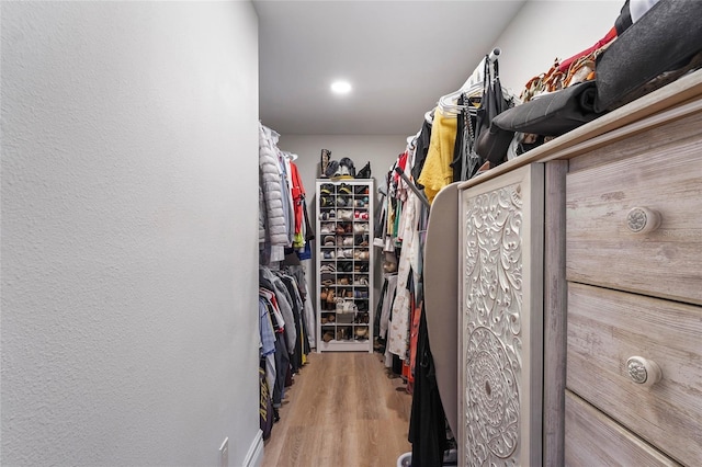 walk in closet featuring light hardwood / wood-style floors