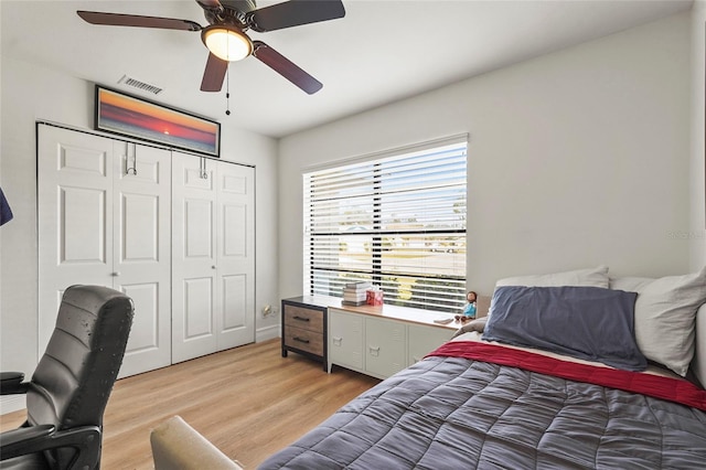 bedroom with a closet, ceiling fan, and light wood-type flooring