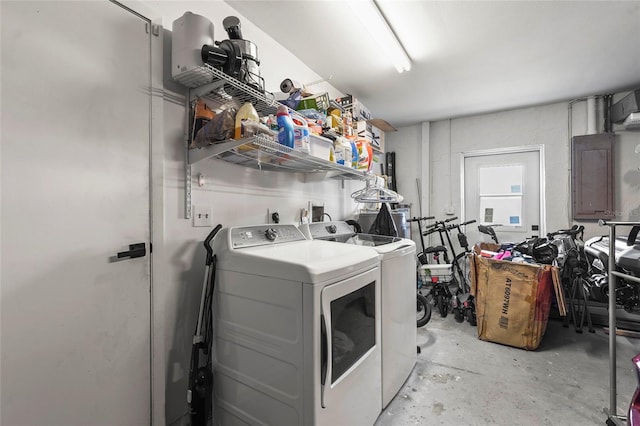 washroom with electric panel and washer and dryer