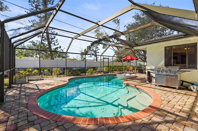 view of swimming pool featuring an in ground hot tub, a patio area, and glass enclosure