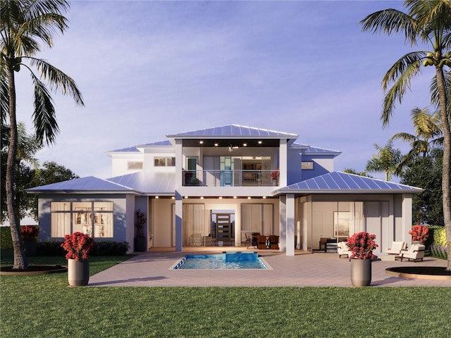 rear view of property featuring a gazebo, a balcony, a yard, and a patio area