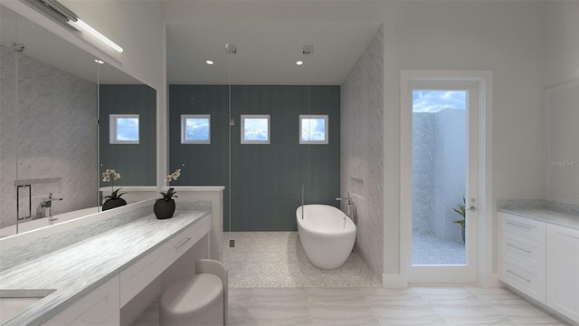 bathroom with vanity, shower with separate bathtub, and tile walls