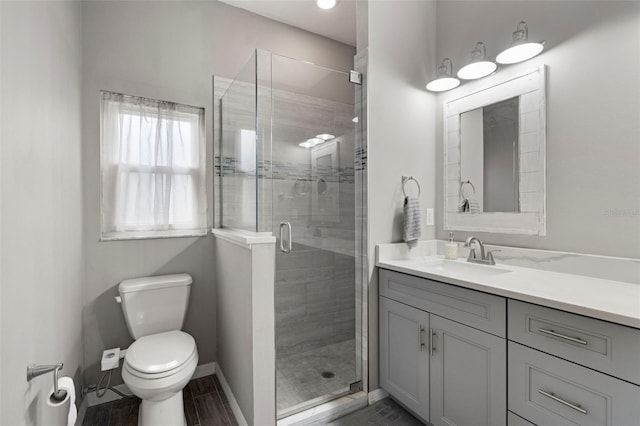 bathroom with vanity, toilet, and walk in shower