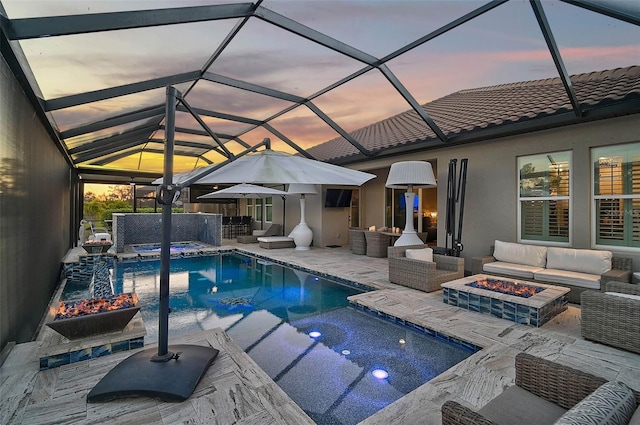 outdoor pool featuring a patio area, an in ground hot tub, and an outdoor living space with a fire pit