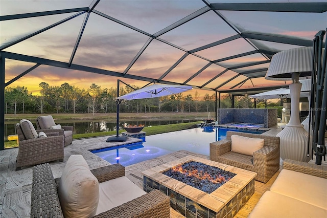 view of patio / terrace with an infinity pool, an in ground hot tub, an outdoor living space with a fire pit, and a lanai