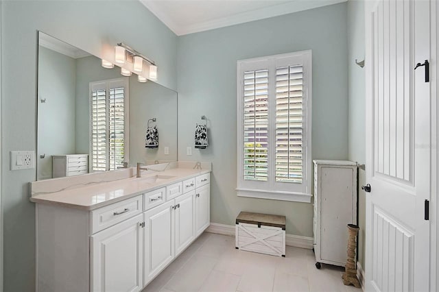 bathroom featuring a wealth of natural light, vanity, baseboards, and tile patterned floors