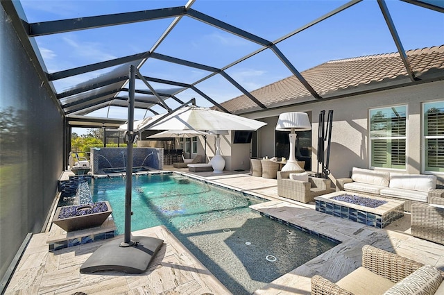 outdoor pool featuring an outdoor living space with a fire pit and a patio