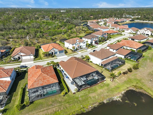 drone / aerial view featuring a water view and a residential view