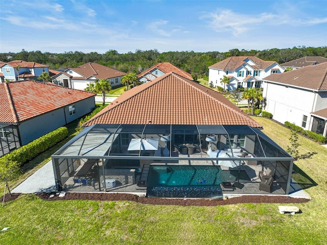 exterior space featuring glass enclosure, a tiled roof, a residential view, and a patio