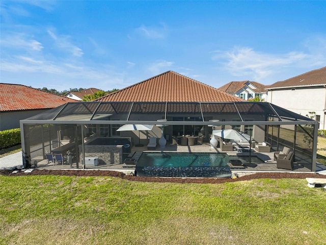 exterior space featuring a patio, a yard, glass enclosure, and an outdoor living space