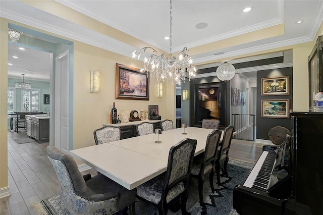 dining room featuring dark wood-style floors, a tray ceiling, crown molding, and recessed lighting