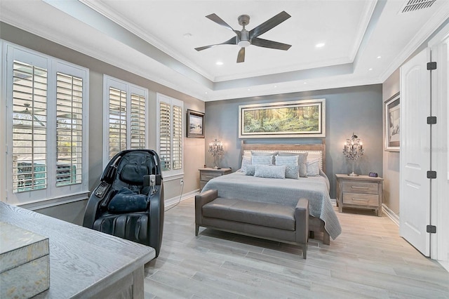 bedroom featuring ornamental molding, a tray ceiling, visible vents, and baseboards