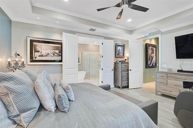 bedroom with ornamental molding, light wood-type flooring, a raised ceiling, and visible vents