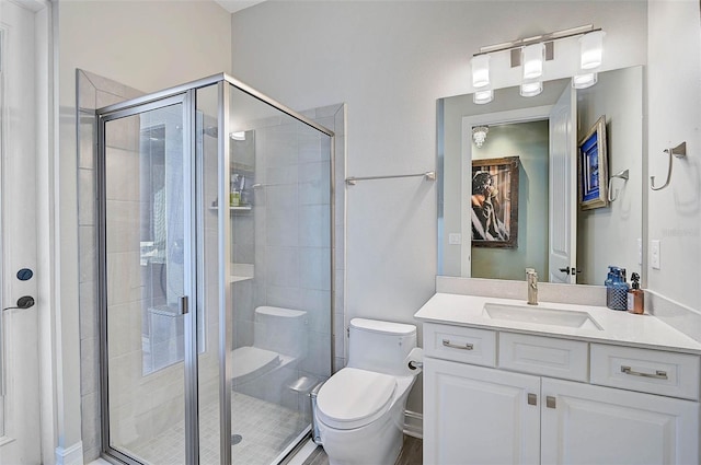 full bath featuring a stall shower, vanity, and toilet