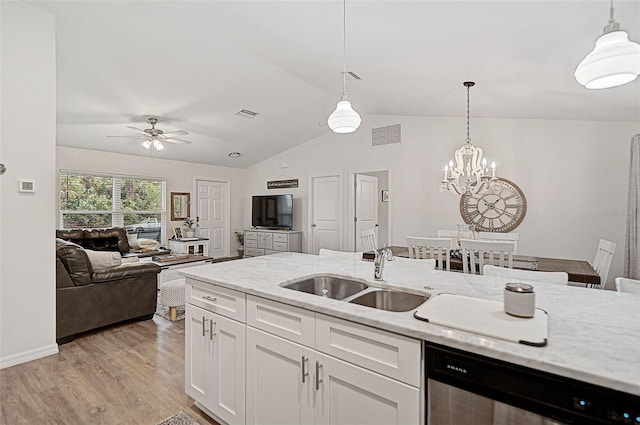 kitchen featuring pendant lighting, sink, dishwasher, light stone counters, and white cabinets