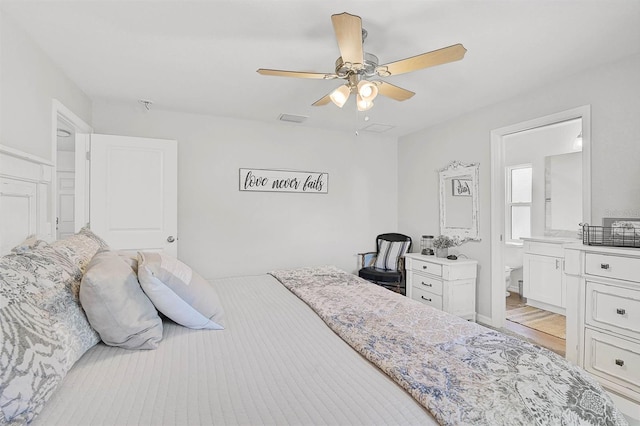 bedroom with light hardwood / wood-style flooring, ceiling fan, and ensuite bathroom