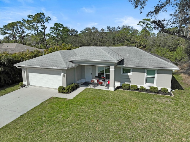 ranch-style house with a garage and a front lawn