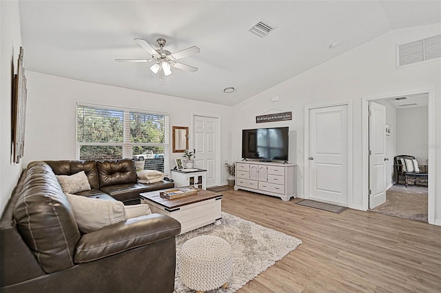 living room featuring vaulted ceiling, ceiling fan, and light wood-type flooring