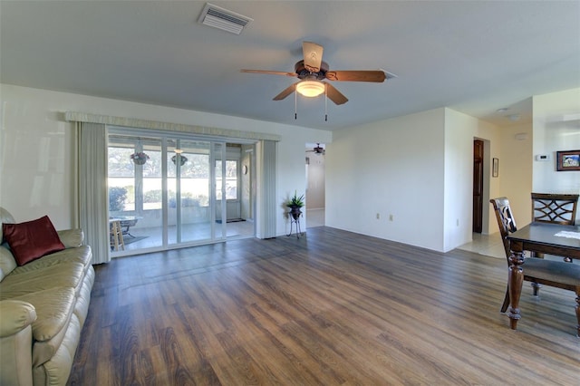 living room with dark hardwood / wood-style floors and ceiling fan