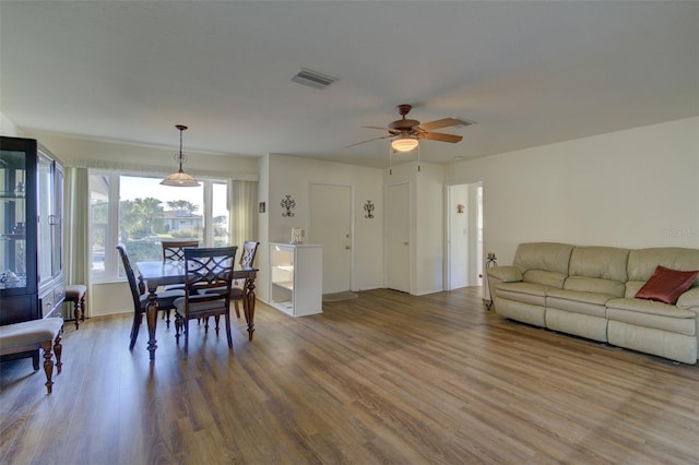 dining area with hardwood / wood-style flooring and ceiling fan