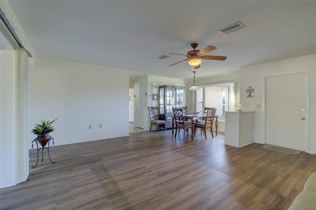 dining room with dark hardwood / wood-style floors and ceiling fan