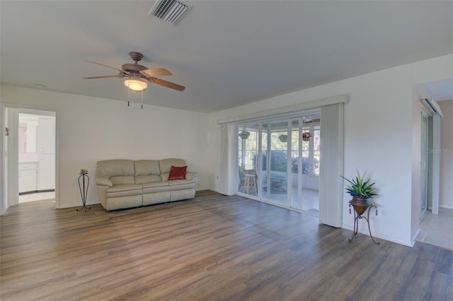 living room with ceiling fan and wood-type flooring