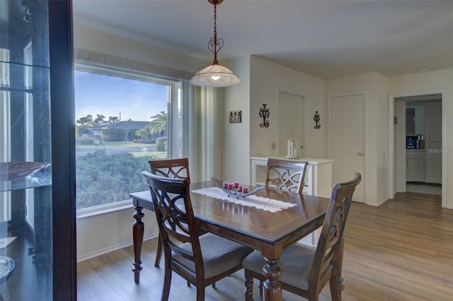 dining space with hardwood / wood-style flooring