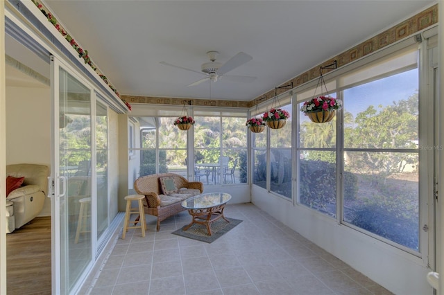 unfurnished sunroom featuring ceiling fan