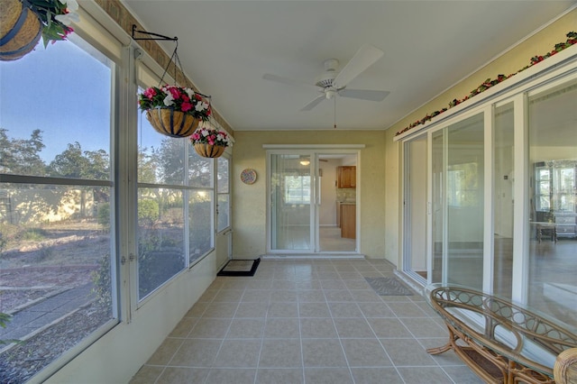 unfurnished sunroom with ceiling fan