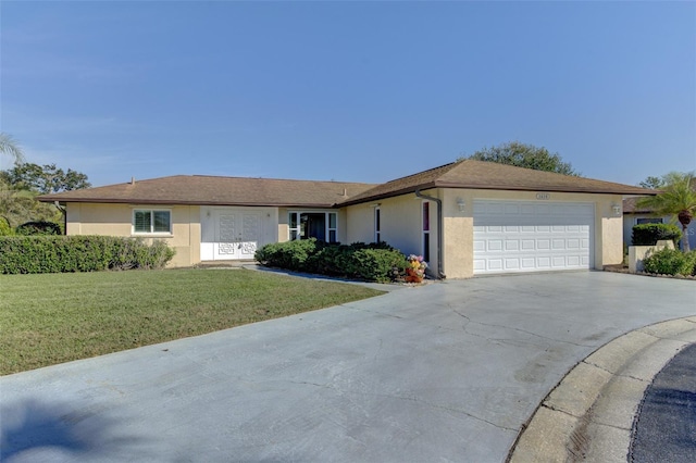 ranch-style home with a garage and a front lawn