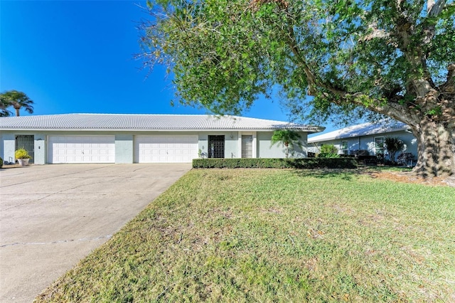 ranch-style home featuring a garage and a front lawn