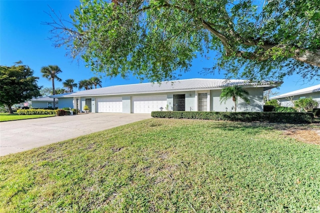 single story home featuring a garage and a front lawn