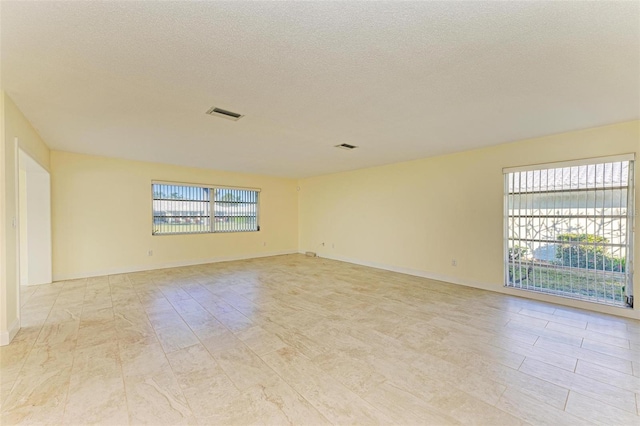 empty room with a textured ceiling