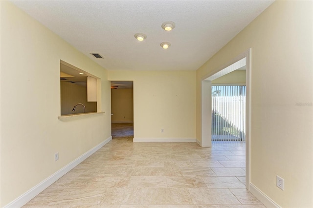 unfurnished room featuring a textured ceiling