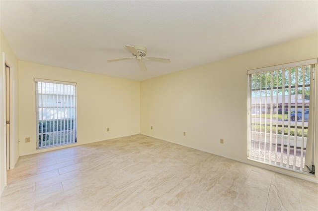 unfurnished room featuring ceiling fan