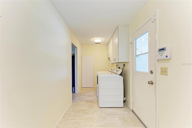 laundry room with cabinets and washing machine and clothes dryer