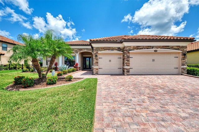 mediterranean / spanish-style home with a garage and a front yard