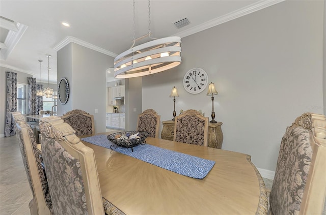 dining space featuring ornamental molding and an inviting chandelier