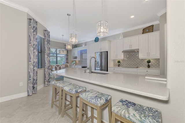 kitchen with stainless steel refrigerator with ice dispenser, hanging light fixtures, ornamental molding, white cabinets, and backsplash