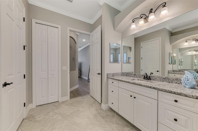 bathroom with tile patterned flooring, vanity, and ornamental molding