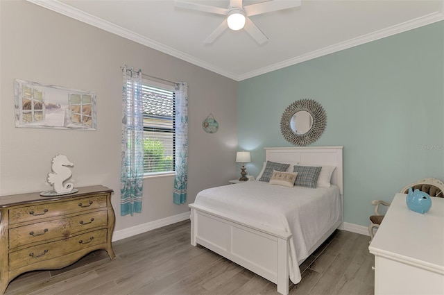 bedroom featuring ornamental molding, ceiling fan, and light wood-type flooring