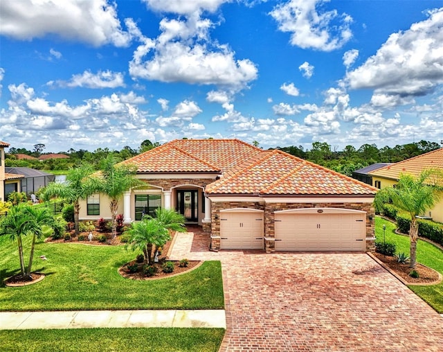 20686 Valprato Ct, Venice, FL 34293 - mediterranean / spanish house featuring driveway, an attached garage, a tiled roof, a front yard, and stone siding