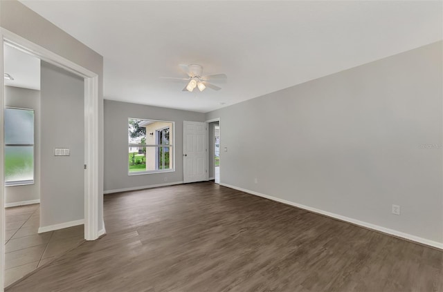 empty room featuring dark hardwood / wood-style flooring and ceiling fan