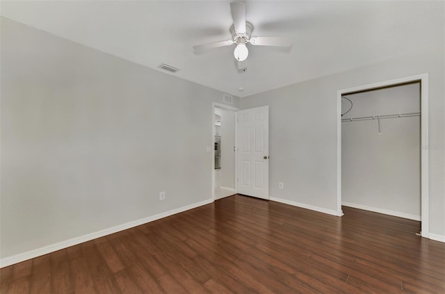 unfurnished bedroom featuring dark wood-type flooring, ceiling fan, and a closet