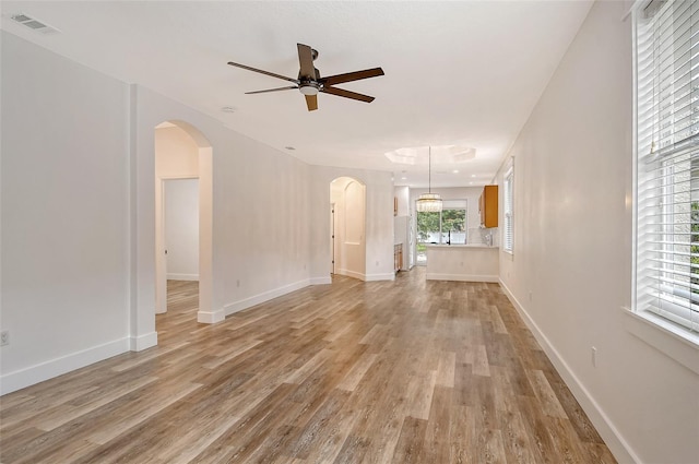 unfurnished living room featuring ceiling fan and light hardwood / wood-style floors