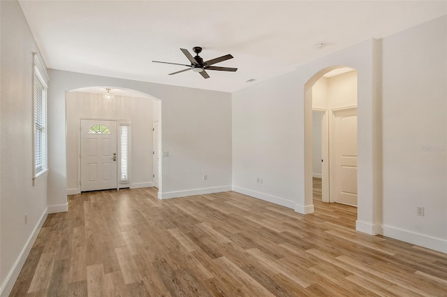 empty room with light hardwood / wood-style floors and ceiling fan